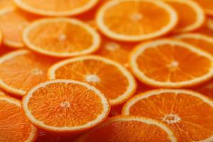 Slices of ripe orange backlit as a textural background. Full screen, close-up, macro photo