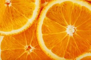 Round orange slices, in the form of texture and lanterns of fresh juicy slices photo