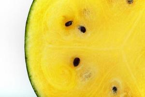 Half a juicy, yellow watermelon on a white background, texture of juicy pulp and mesmeses of ripe watermelon photo