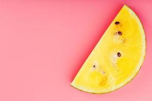 Juicy slices of yellow watermelon on a bright pink background. Conceptual colors of summer. Patterns top view as a background or substrate, photo