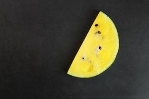 Slices of yellow watermelon on a pink background in the form. Minimal food concept idea. Flat lay photo