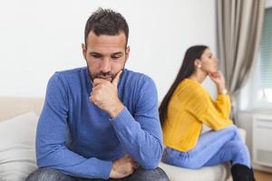 People, relationship difficulties, conflict and family concept - Unhappy couple having argument at home. Couple Having Argument At Home. Troubled woman expressing despair photo