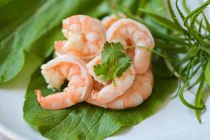 Fresh shrimp on fresh vegetables, cooked shrimps prawns for seafood with herb cannabis leaf and coriander, cooking boiled shrimp photo