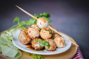 Meatballs on plate with with spicy sauce, Grilled meatball and pork ball, Meat ball on skewers and fresh coriander vegetables cabbage, Thai food Asian food Meat balls - pork balls photo