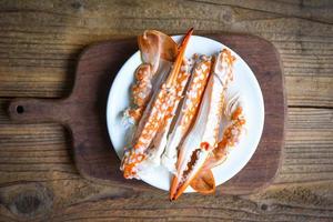 Boiled crab food on wooden board on the table, crab claws shellfish photo