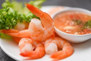 Shrimp delicious seasoning spices on white plate appetizing cooked boiled shrimps prawns , salad shelfish seafood sauce photo