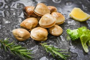 Seafood shellfish on ice frozen at the restaurant - Fresh shell clam with herb ingredients for salad , enamel venus shell , saltwater clams photo