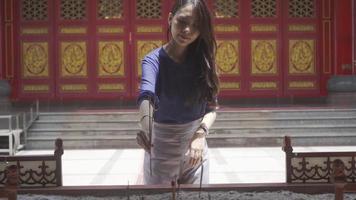 An Attractive girl praying at a Chinese shrine in Bangkok, Thailand. video