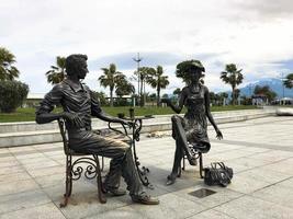 Abstract statues, small architectural forms of people drinking tea on Batumi seaside boulevard or Batumi Beach. Georgia, Batumi, April 17, 2019 photo