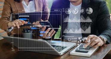 Businessman hand Project manager working and update tasks and Gantt chart scheduling virtual diagram.with smart phone, tablet and laptop in office. photo