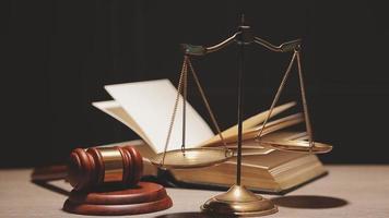 Justice and law concept.Male judge in a courtroom with the gavel, working with, computer and docking keyboard, eyeglasses, on table in morning light video