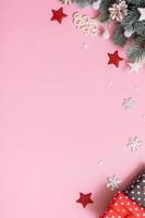 Pine trees branches with Cristmas New Year decoration top view, flat lay on pink background with copy space. Blank greeting card photo