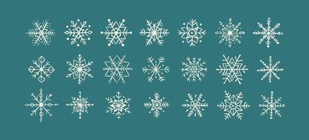 colección de copos de nieve dibujados a mano aislados sobre fondo azul. icono de garabato de copo de nieve vector