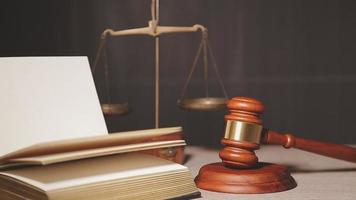 Justice and law concept.Male judge in a courtroom with the gavel, working with, computer and docking keyboard, eyeglasses, on table in morning light video