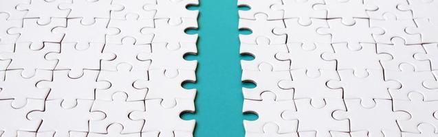 The blue path is laid on the platform of a white folded jigsaw puzzle. Texture image with copy space for text photo