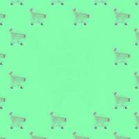 Shopping addiction, shopping lover or shopaholic concept. Many small empty shopping carts perform a pattern on a pastel colored paper background. Flat lay composition, top view photo