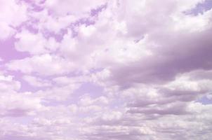 A blue sky with lots of white clouds of different sizes photo