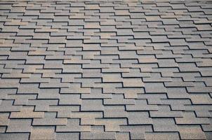 Modern roofing and decoration of chimneys. Flexible bitumen or slate shingles photo