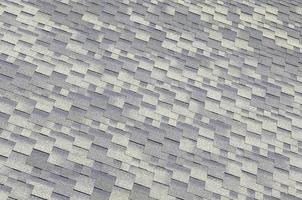 Background mosaic texture of flat roof tiles with bituminous coating photo