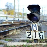 Semaphore with burning blue light. The intersection of railway tracks photo