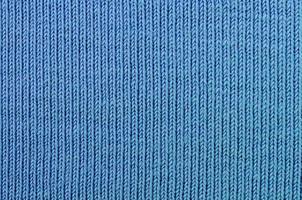 The texture of the fabric in blue color. Material for making shirts and blouses photo