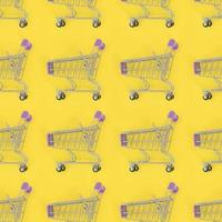 Shopping addiction, shopping lover or shopaholic concept. Many small empty shopping carts perform a pattern on a pastel colored paper background. Flat lay composition, top view photo