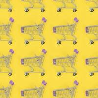 Shopping addiction, shopping lover or shopaholic concept. Many small empty shopping carts perform a pattern on a pastel colored paper background. Flat lay composition, top view photo