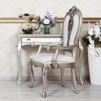 A fragment of a retro interior with a chair and a desk on which is located a telephone and a vase of flowers photo