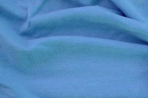 The texture of the fabric in blue color. Material for making shirts and blouses photo