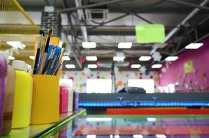 Art paint brushes in cup located in the children's entertainment hall photo