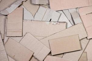 Background image with a lot of beige cardboard paper, which is used to make boxes for the transport of home appliances and postal parcels. Carton texture