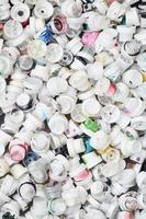 A pattern of many used and soiled nozzles from spray cans with aerosol paint. Background texture of the street art of drawing graffiti on the walls photo
