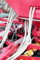 Springs and tubes are arranged in a row. A row of seeder. Heavy equipment on agricultural exhibition photo