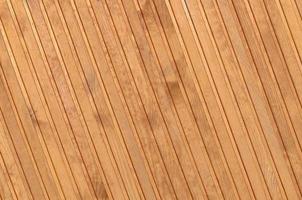 Close up of brown wooden fence panels. Many vertical wooden planks photo