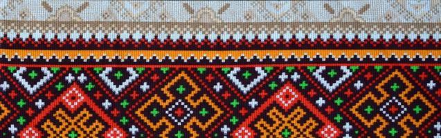 Traditional Ukrainian folk art knitted embroidery pattern on textile fabric photo