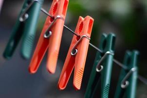 Clothespins on a rope hanging outside house and apple tree photo