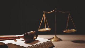 Justice and law concept.Male judge in a courtroom with the gavel, working with, computer and docking keyboard, eyeglasses, on table in morning light video