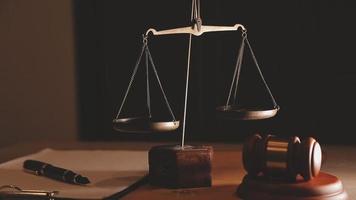 Justice and law concept.Male judge in a courtroom with the gavel, working with, computer and docking keyboard, eyeglasses, on table in morning light video