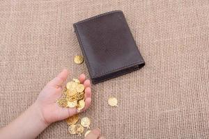 Wallet and fake gold coins on canvas photo
