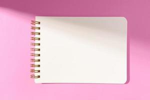 Blank white paper notebook Isolated on pink background. Template mock up photo