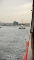Feeding flying seagulls by throwing bagels from a ferry on the go in Istanbul video
