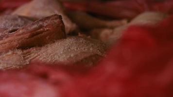 Close-up view of hands in gloves packing chicken legs from a box into individual plastic bags. Process of freezing meat for further use at home. 4k video with light play