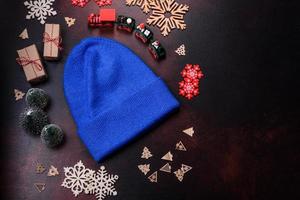 Blue knitted warm cap on dark brown concrete background photo