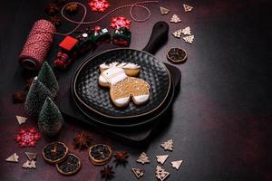 Beautiful different Christmas decorations and gingerbread on a brown concrete table photo