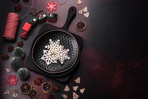 Beautiful different Christmas decorations and gingerbread on a brown concrete table