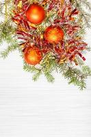 three orange Xmas balls and twig on blank paper photo