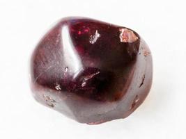 polished red garnet gemstone on white photo