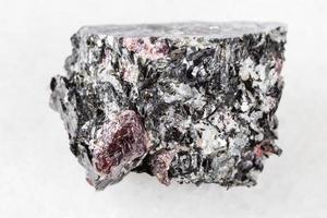 unpolished red Garnet crystals in Biotite on white photo