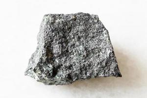 rough Magnetite ore on white marble photo