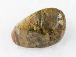 polished unakite gem stone on white photo